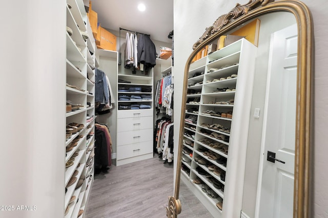 walk in closet featuring light hardwood / wood-style flooring