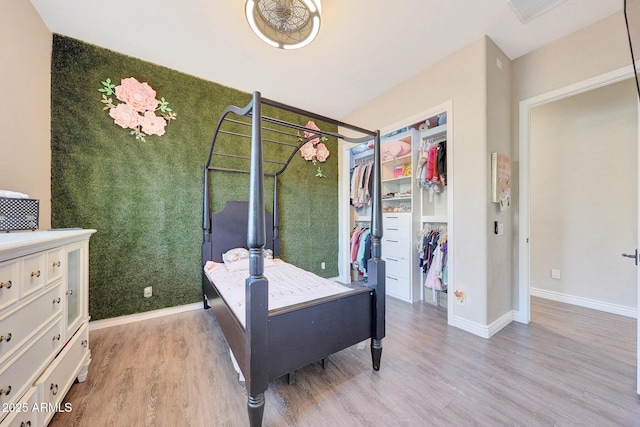 bedroom with wood-type flooring and a closet