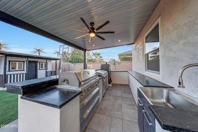 view of patio / terrace with area for grilling, sink, ceiling fan, and an outdoor kitchen