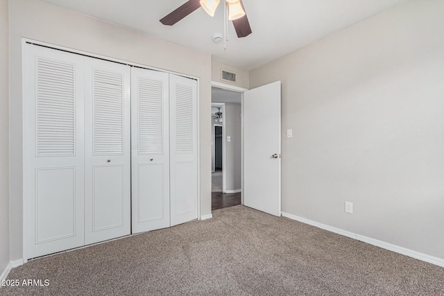 unfurnished bedroom featuring ceiling fan, a closet, and carpet