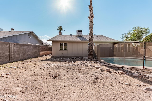 back of house featuring a fenced in pool