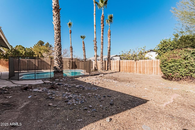 view of yard with a fenced in pool