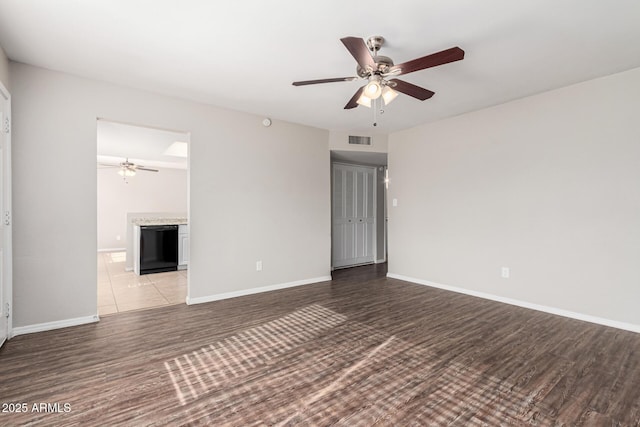 spare room with light wood-type flooring and ceiling fan