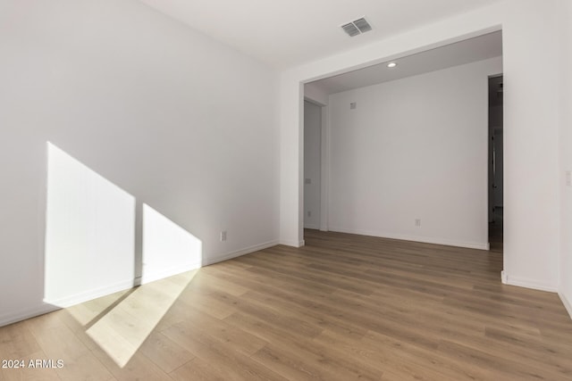 spare room featuring hardwood / wood-style floors