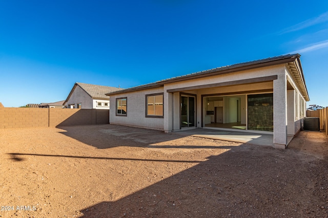 back of house with central AC and a patio