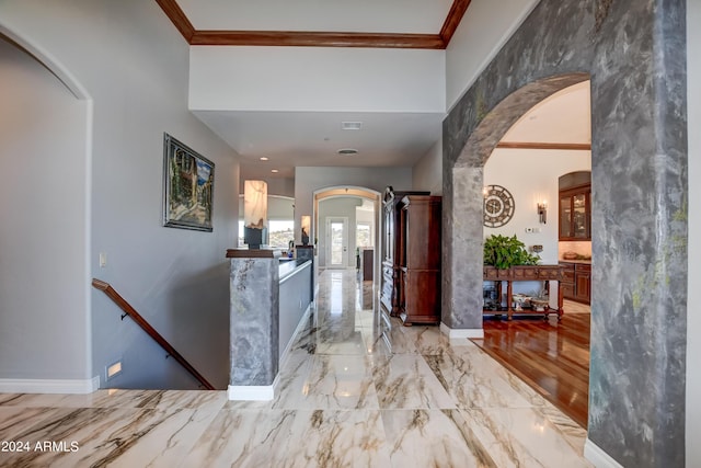 corridor featuring light tile patterned floors and crown molding