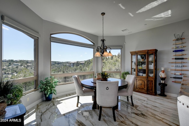 tiled dining area with a notable chandelier and a healthy amount of sunlight