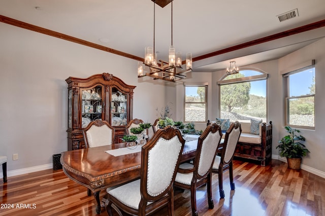 dining area with hardwood / wood-style flooring and a chandelier