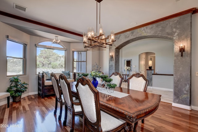 dining room with hardwood / wood-style flooring and an inviting chandelier