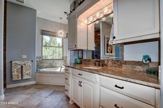 bathroom featuring tile patterned flooring, a bathtub, and vanity