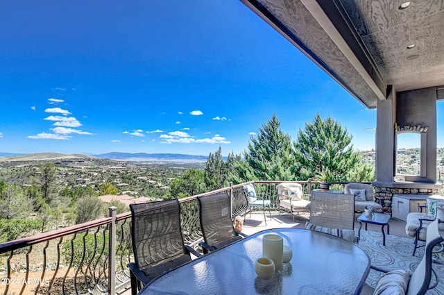 balcony featuring a mountain view and an outdoor living space