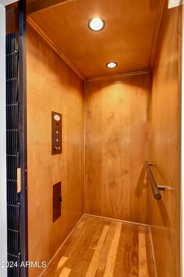 interior details featuring ornamental molding and elevator