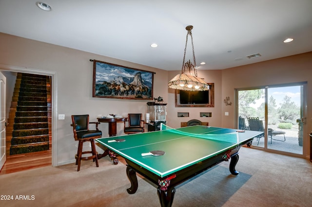recreation room featuring light colored carpet