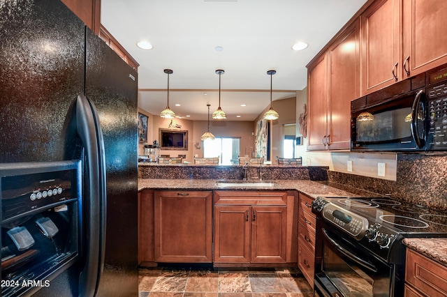 kitchen featuring backsplash, sink, tile patterned flooring, hanging light fixtures, and black appliances