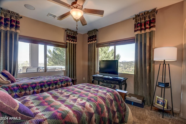 bedroom with ceiling fan and carpet flooring