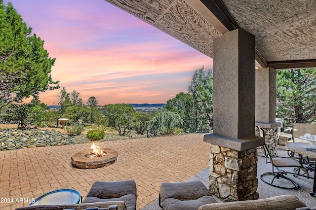 patio terrace at dusk with an outdoor fire pit