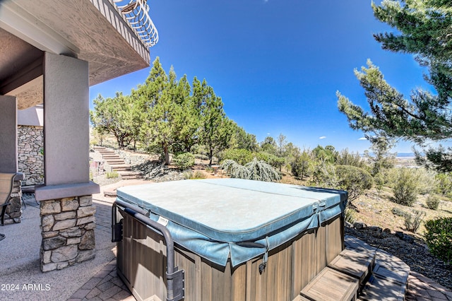 view of patio / terrace with a hot tub