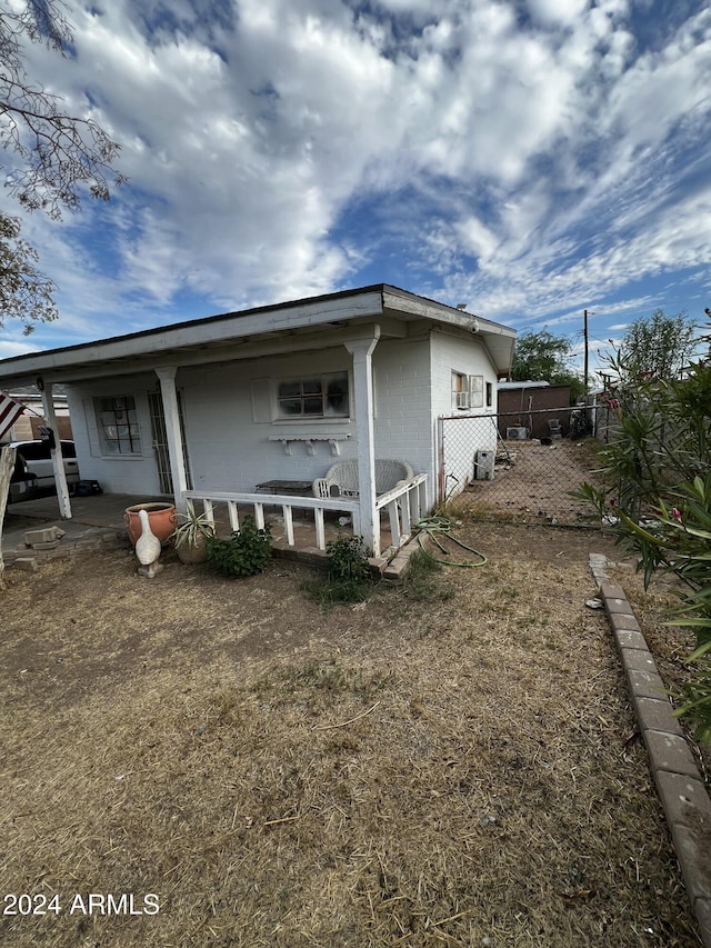 view of side of property featuring a porch