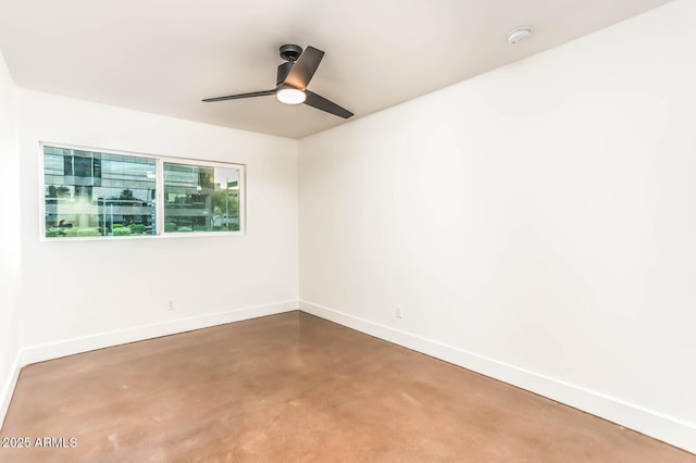 empty room with ceiling fan and concrete floors