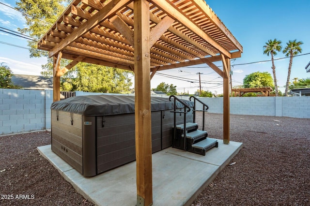 view of patio with a hot tub and a pergola