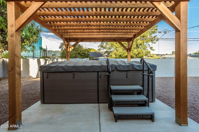 view of patio with a pergola and a hot tub