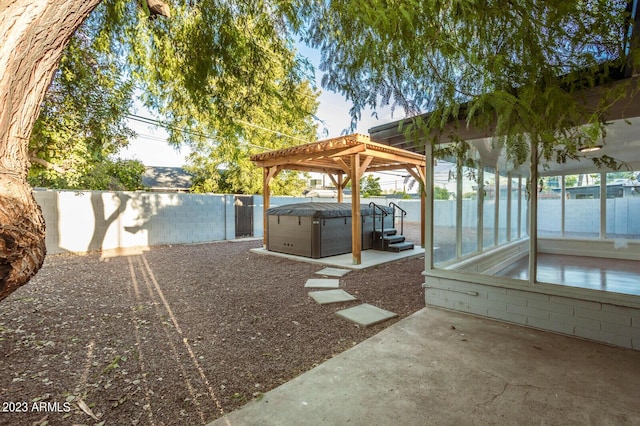 view of patio / terrace featuring a pergola and a hot tub