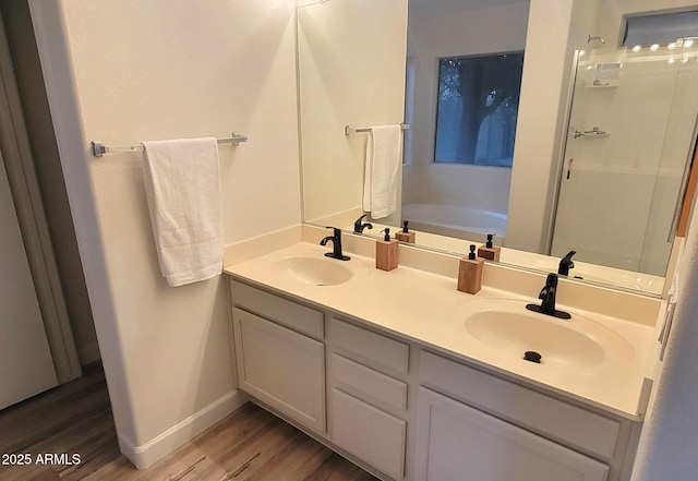 bathroom featuring vanity, hardwood / wood-style flooring, and shower with separate bathtub