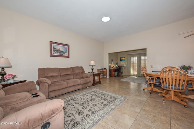 tiled living room featuring french doors and ceiling fan