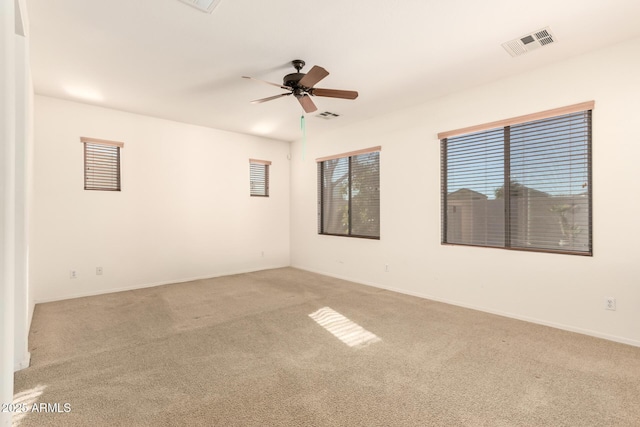 carpeted spare room with ceiling fan