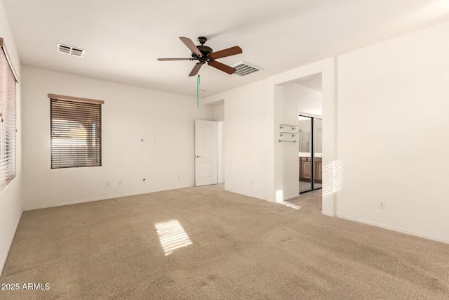 unfurnished room featuring ceiling fan and light colored carpet