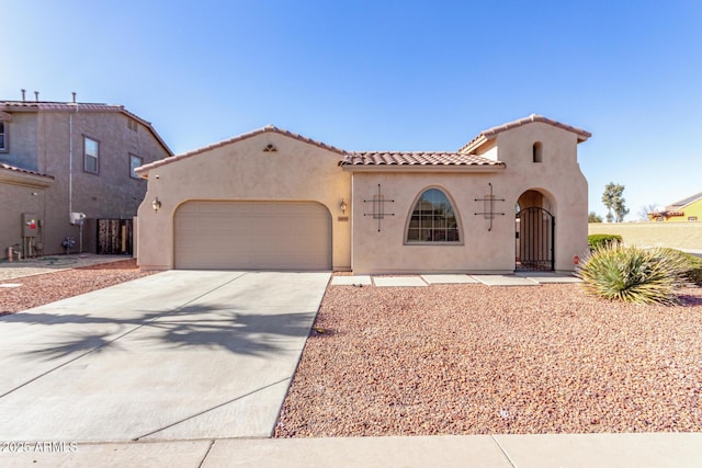 mediterranean / spanish-style home with a garage