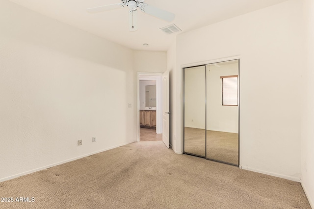 unfurnished bedroom featuring light carpet, a closet, and ceiling fan