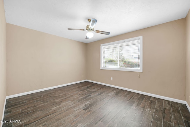 unfurnished room featuring dark wood-type flooring and ceiling fan