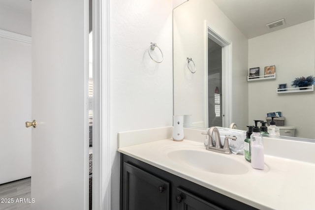 bathroom with vanity, hardwood / wood-style floors, and toilet