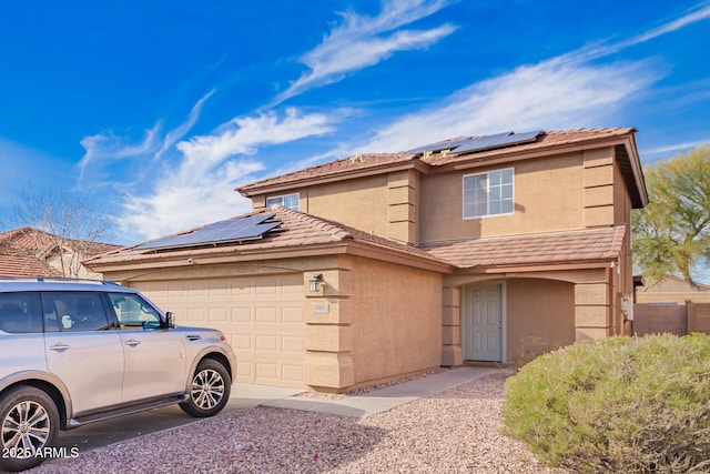 front of property with a garage and solar panels