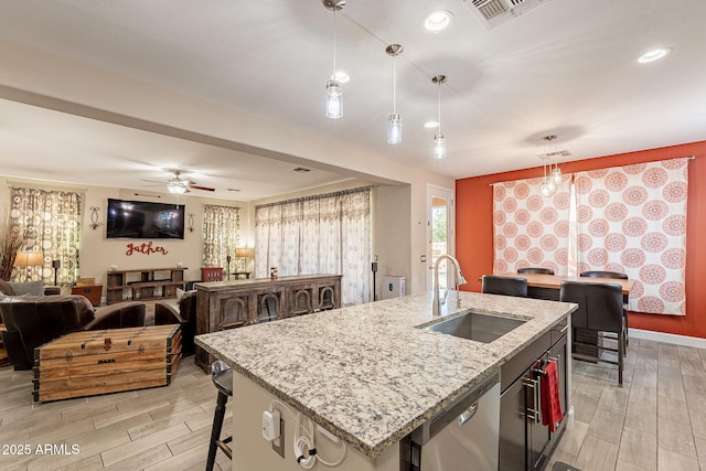5012 S Girard St, Gilbert, AZ 85298 - kitchen featuring open floor plan, light wood-style floors, visible vents, stainless steel dishwasher, and a sink