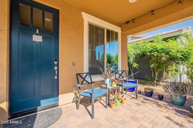 5012 S Girard St, Gilbert, AZ 85298 - view of exterior entry featuring a patio and stucco siding
