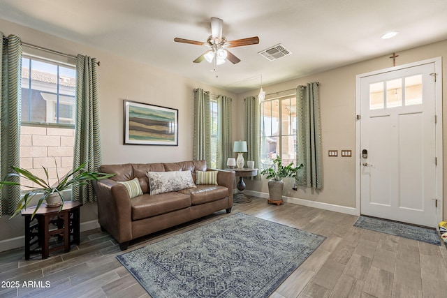 5012 S Girard St, Gilbert, AZ 85298 - living area featuring visible vents, baseboards, a ceiling fan, and wood finished floors