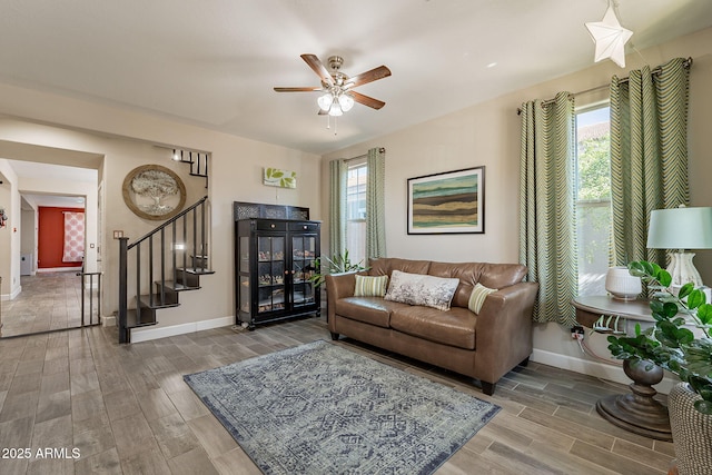 5012 S Girard St, Gilbert, AZ 85298 - living room featuring baseboards, a healthy amount of sunlight, wood finished floors, and stairs