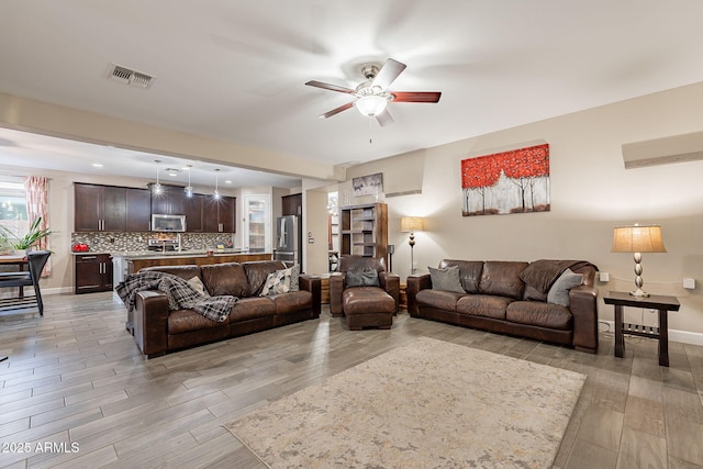 5012 S Girard St, Gilbert, AZ 85298 - living area featuring baseboards, visible vents, light wood-type flooring, and a ceiling fan