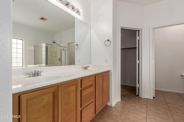 bathroom featuring vanity, an enclosed shower, and tile patterned floors