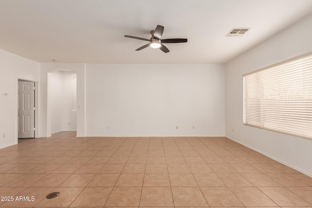 tiled spare room with ceiling fan