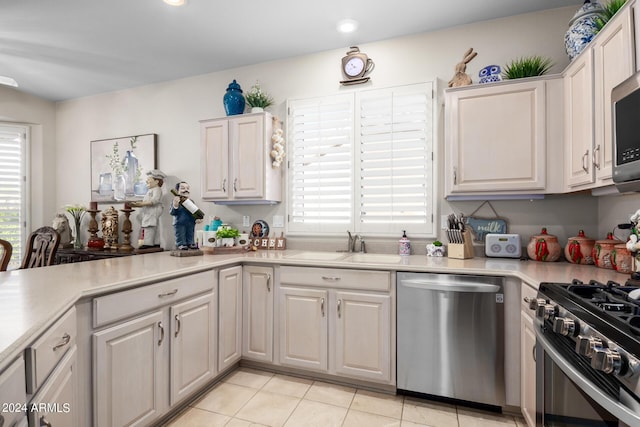 kitchen with white cabinets, appliances with stainless steel finishes, and light countertops