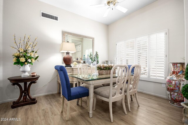 dining area featuring a ceiling fan, visible vents, light wood-style flooring, and baseboards