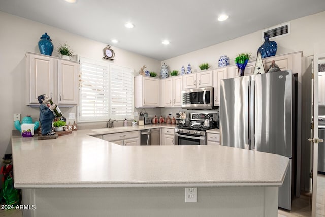 kitchen featuring recessed lighting, appliances with stainless steel finishes, light countertops, visible vents, and a peninsula