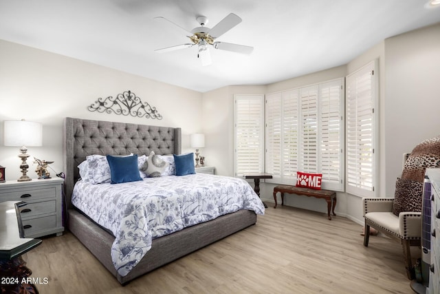 bedroom featuring wood finished floors, ceiling fan, and baseboards