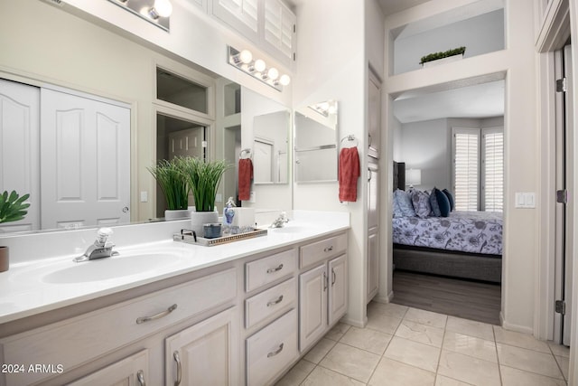ensuite bathroom featuring double vanity, a sink, and ensuite bathroom