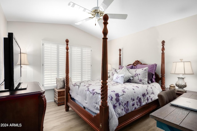 bedroom featuring ceiling fan, vaulted ceiling, and wood finished floors