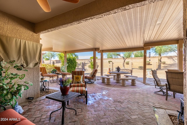 view of patio / terrace with outdoor dining area, a ceiling fan, and fence