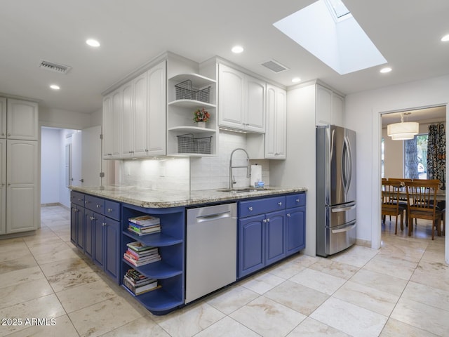 kitchen with appliances with stainless steel finishes, visible vents, a sink, and open shelves